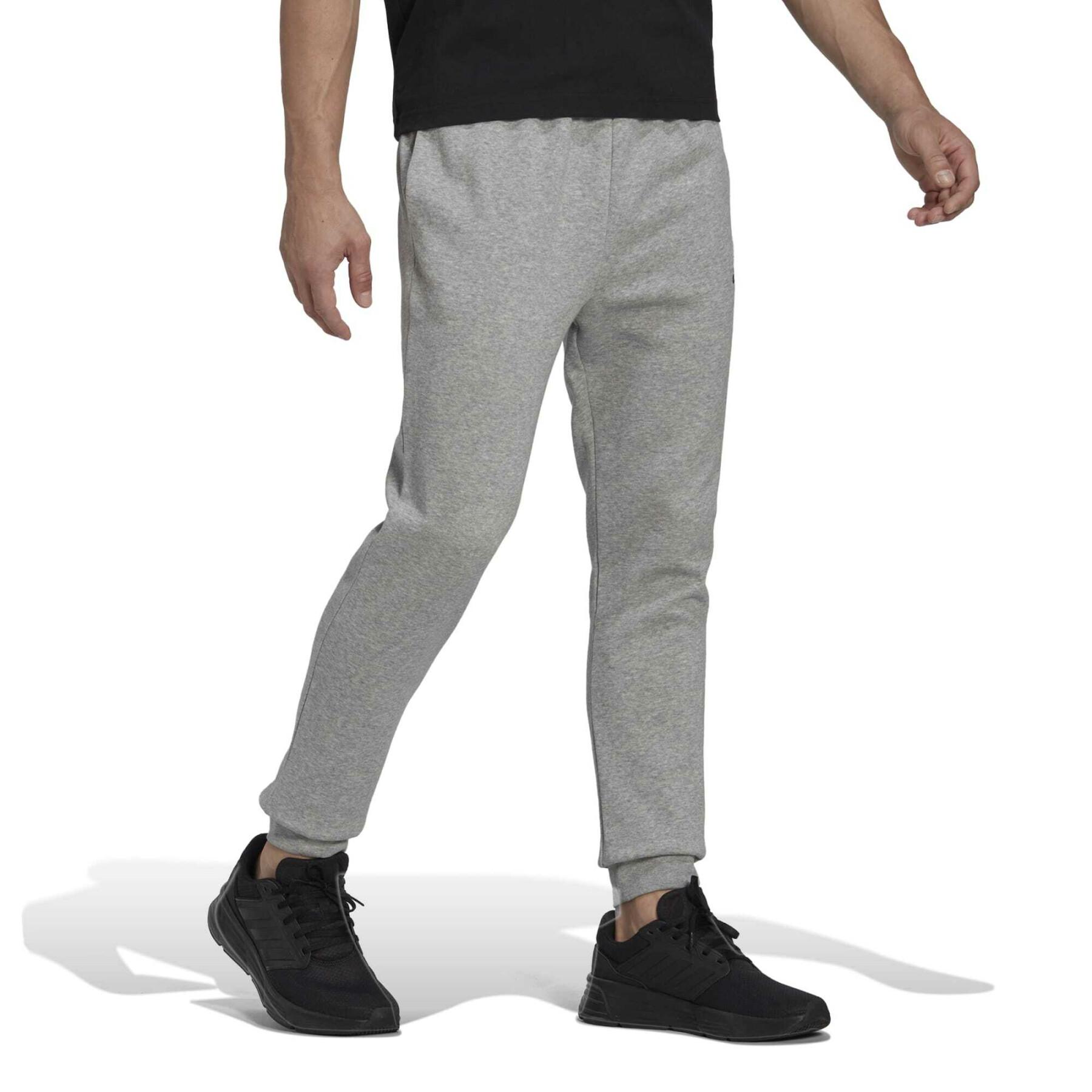 Avsmalnande joggingbyxor i fleece adidas Essentials